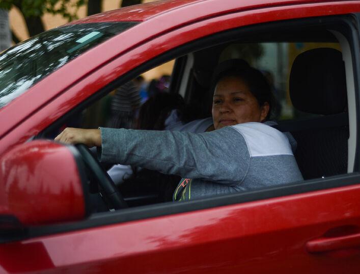 Delmi Santos waits for her child in the pick up line in on Monday